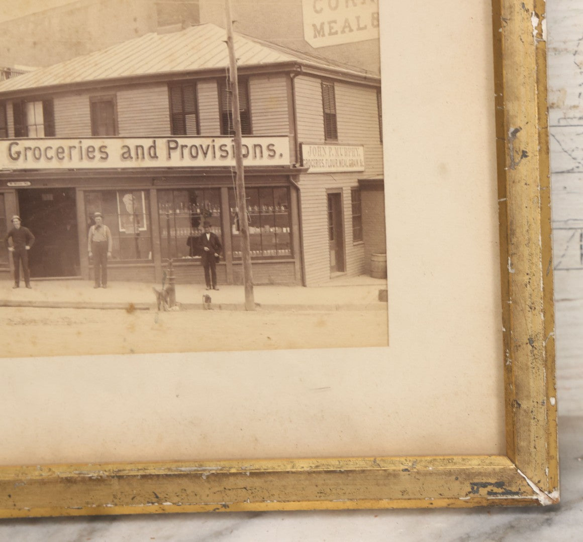 Lot 035 - Antique Occupational Photograph Depicting The Proprietors And Workers Of John P. Murphy Groceries And Provisions General Store, Located On West Main Street, Unknown City, Dog Visible In Photograph, In Period Frame, As Found, 11-1/2" x 8-1/2"