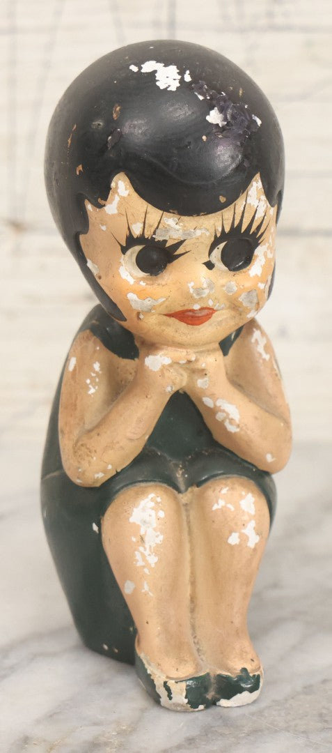 Lot 044 - Vintage Chalkware Kewpie-Style Crouching Flapper Doll With Black Hair And Green Dress, Back Marked "Splash Me", Note Paint Chipping And Wear, 4-3/4" Height