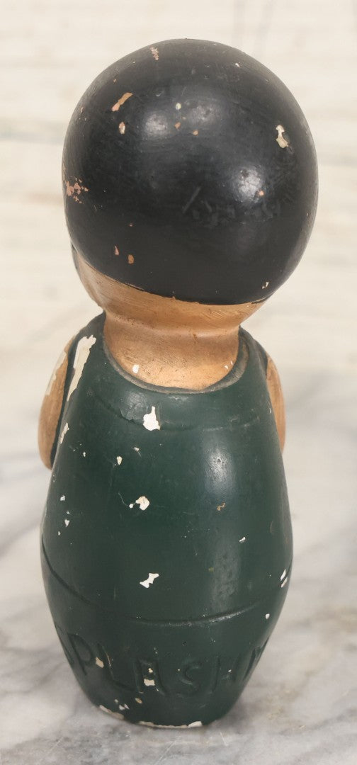 Lot 044 - Vintage Chalkware Kewpie-Style Crouching Flapper Doll With Black Hair And Green Dress, Back Marked "Splash Me", Note Paint Chipping And Wear, 4-3/4" Height