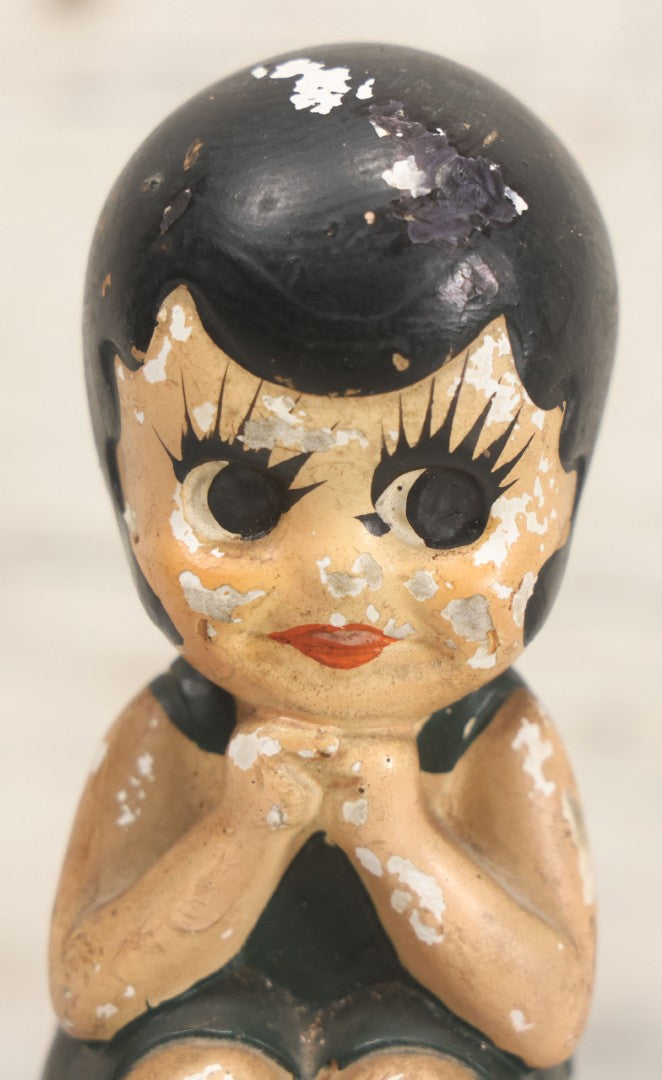 Lot 044 - Vintage Chalkware Kewpie-Style Crouching Flapper Doll With Black Hair And Green Dress, Back Marked "Splash Me", Note Paint Chipping And Wear, 4-3/4" Height