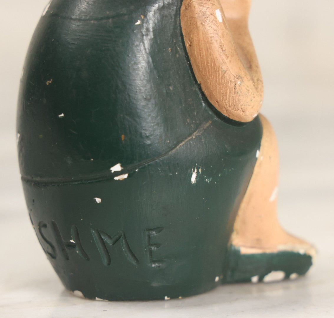 Lot 044 - Vintage Chalkware Kewpie-Style Crouching Flapper Doll With Black Hair And Green Dress, Back Marked "Splash Me", Note Paint Chipping And Wear, 4-3/4" Height