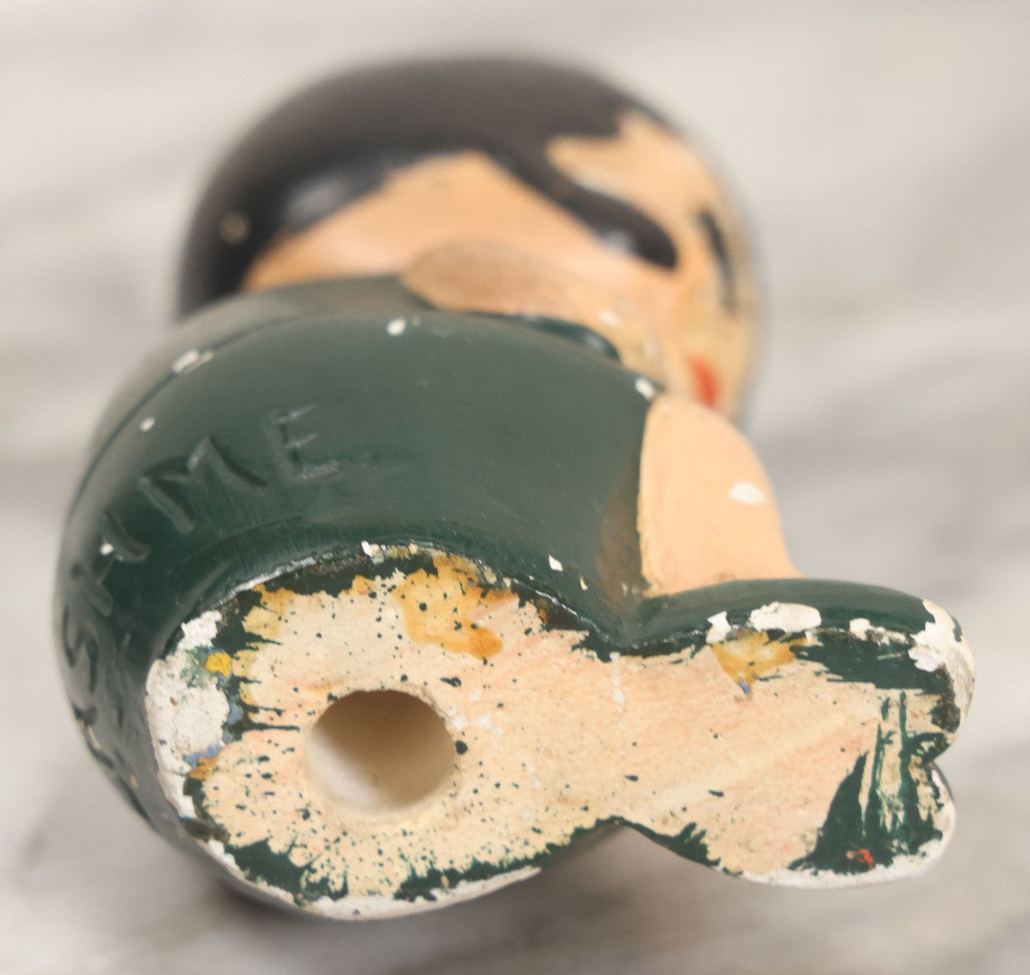 Lot 044 - Vintage Chalkware Kewpie-Style Crouching Flapper Doll With Black Hair And Green Dress, Back Marked "Splash Me", Note Paint Chipping And Wear, 4-3/4" Height