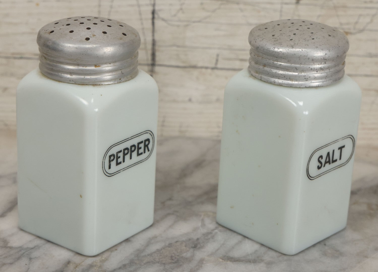 Lot 048 - Vintage Mid Century Milk Glass Salt And Pepper Shakers With Tin Lids And Black Lettering, 4-7/8" Height Each