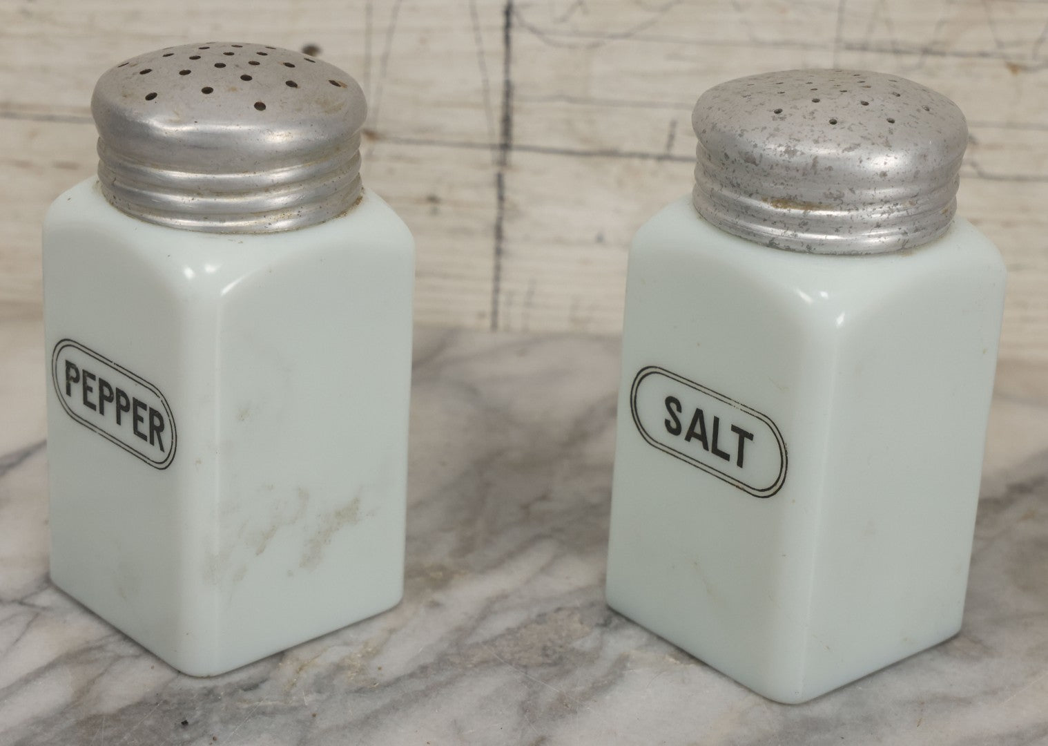 Lot 048 - Vintage Mid Century Milk Glass Salt And Pepper Shakers With Tin Lids And Black Lettering, 4-7/8" Height Each