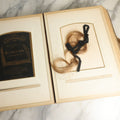 Lot 059 - Antique Photo And Keepsake Album With Cabinet Card, Tintype, And C.D.V. Photos, Remembrance Card & Hair From Mrs. Laura E. Little, Hidden Mother Tintype With Scratched Out Face, Photo Of Back Of Woman's Hair, Textile Keepsakes, Pressed Foliage