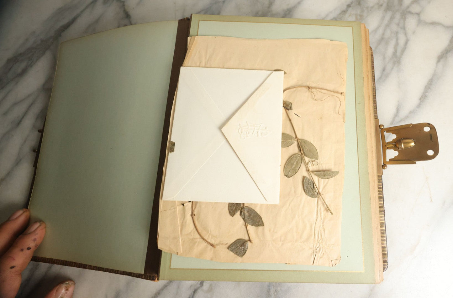 Lot 059 - Antique Photo And Keepsake Album With Cabinet Card, Tintype, And C.D.V. Photos, Remembrance Card & Hair From Mrs. Laura E. Little, Hidden Mother Tintype With Scratched Out Face, Photo Of Back Of Woman's Hair, Textile Keepsakes, Pressed Foliage