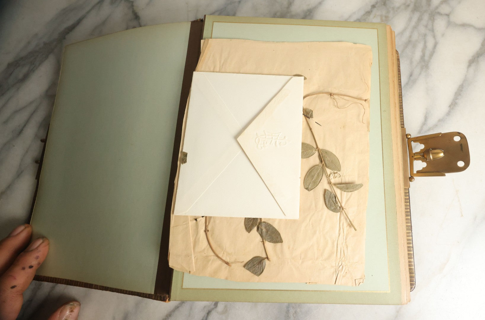 Lot 059 - Antique Photo And Keepsake Album With Cabinet Card, Tintype, And C.D.V. Photos, Remembrance Card & Hair From Mrs. Laura E. Little, Hidden Mother Tintype With Scratched Out Face, Photo Of Back Of Woman's Hair, Textile Keepsakes, Pressed Foliage