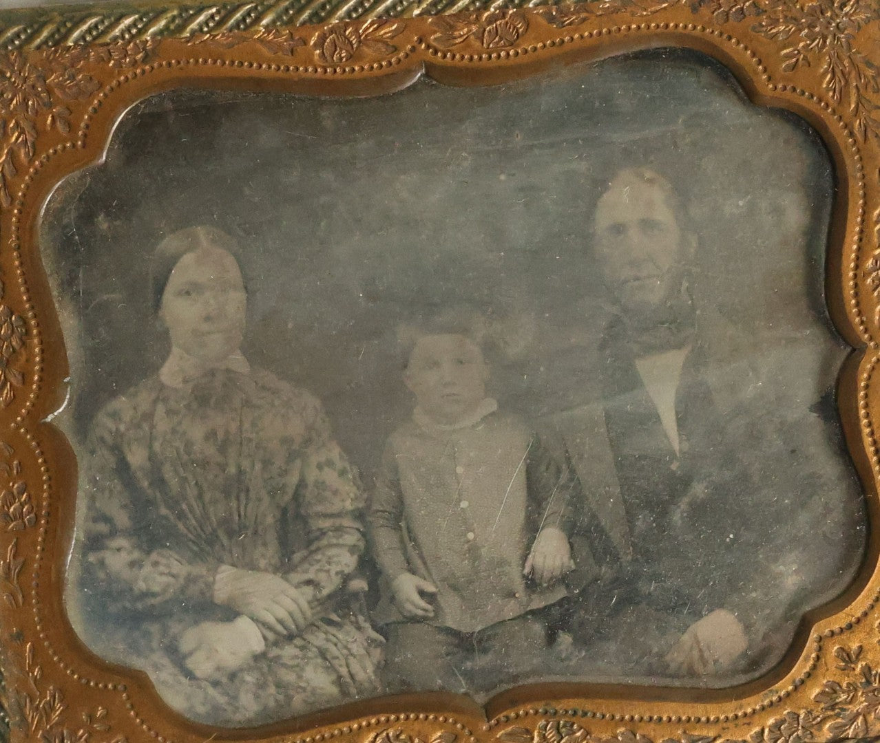Lot 067 - Antique 1/6th Plate Daguerreotype Photograph Of Mother, Father, And Their Little Boy, Note Cleaning Marks On Photo. No Case.