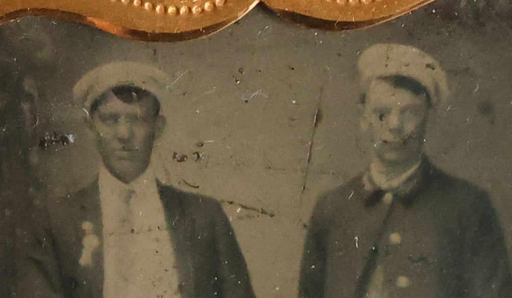 Lot 070 - Antique 1/6th Plate Tintype Photograph With Brass Mat And Preserver Of Four Well Dressed Fraternal Men Wearing Hats And Badges
