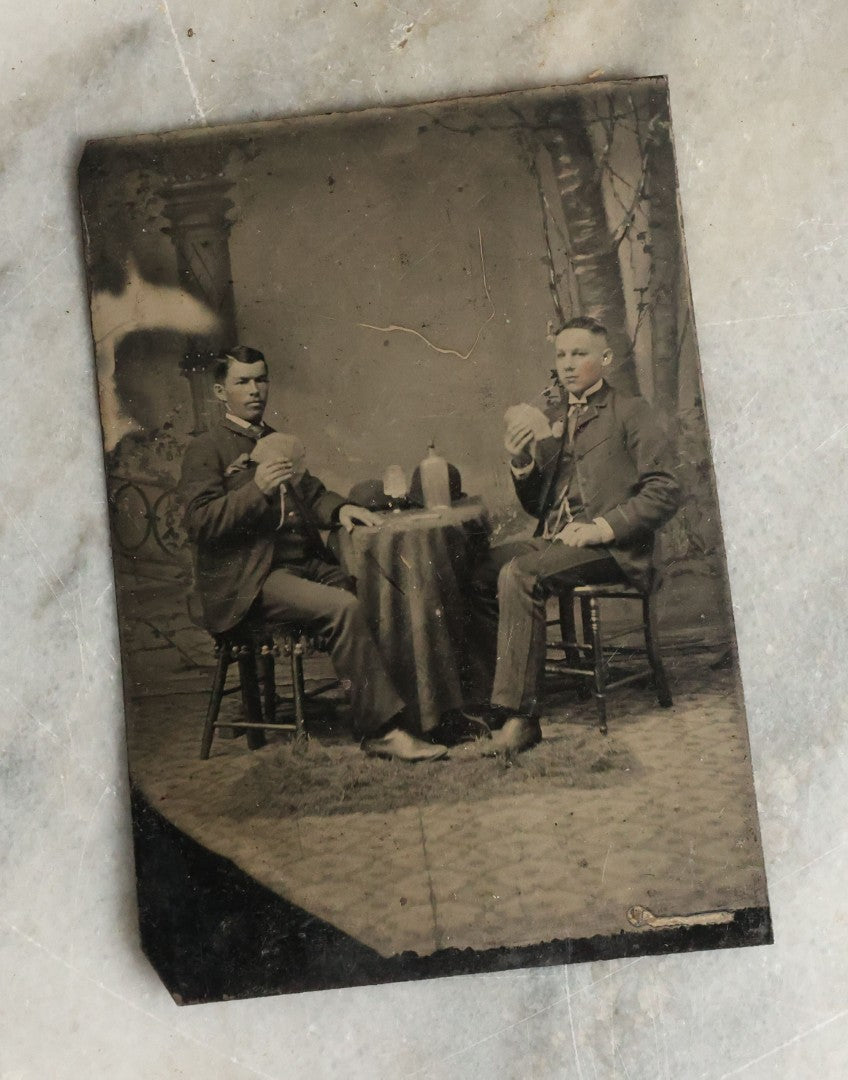 Lot 072 - Single Antique Tintype Photograph Of Two Young Men Playing Cards And Drinking With Bowler Hats On Small Table