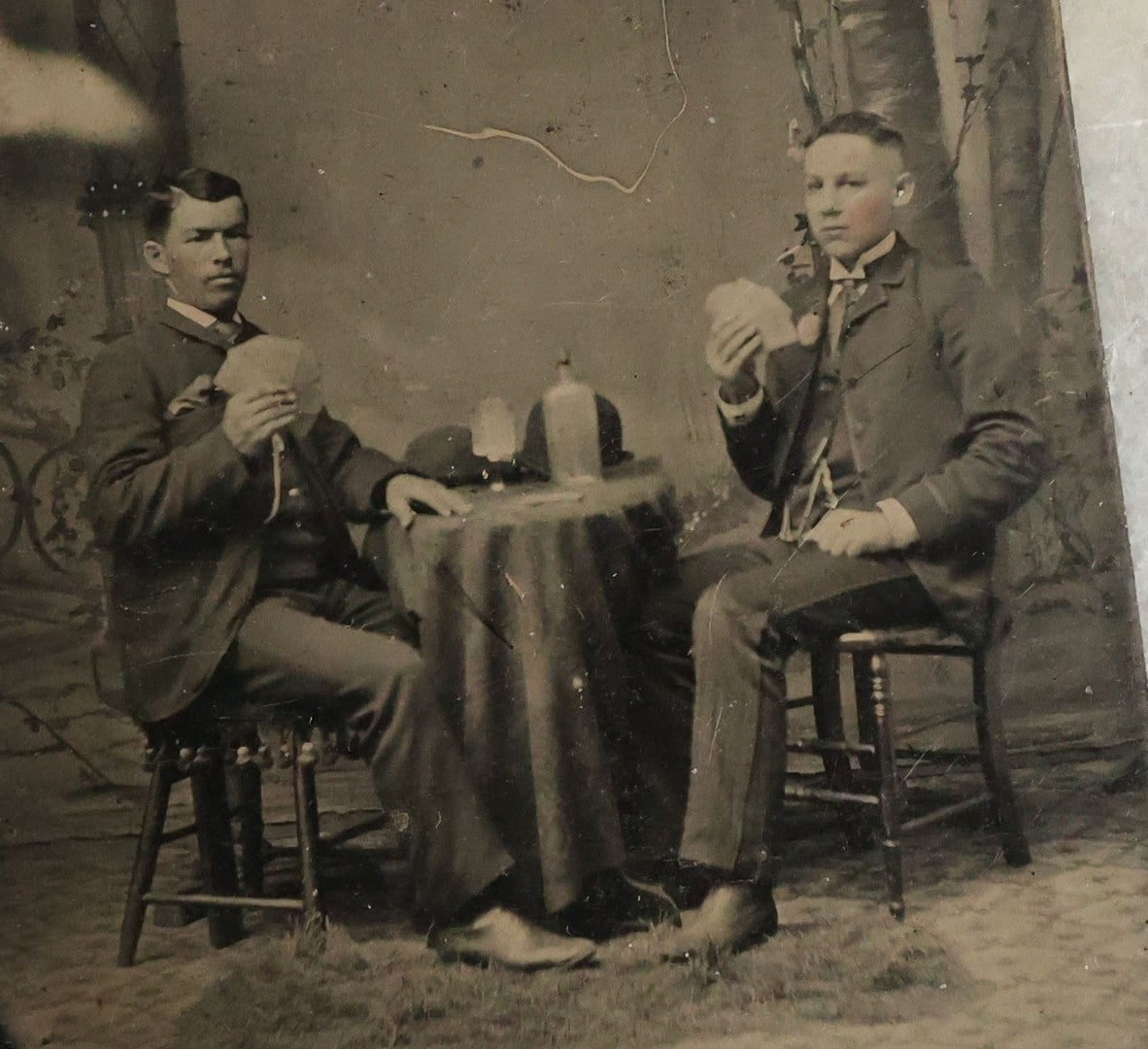 Lot 072 - Single Antique Tintype Photograph Of Two Young Men Playing Cards And Drinking With Bowler Hats On Small Table