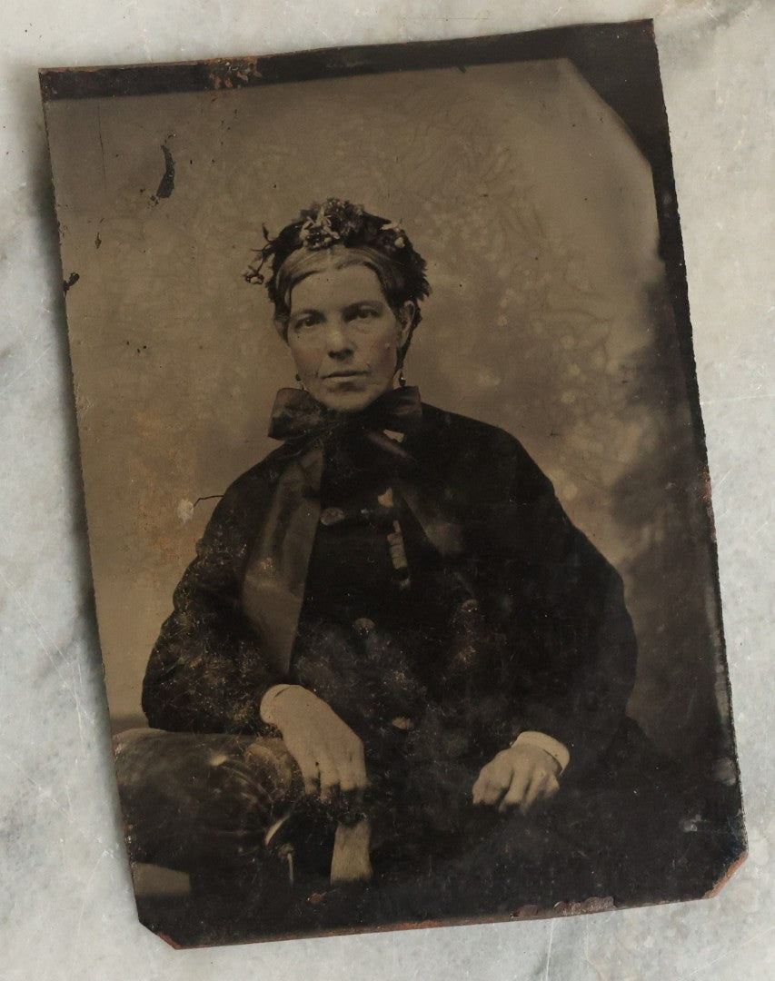 Lot 075 - Pair Of Tintype Photographs Of An Old Man With Large Hands And Unusual Face And Big Bushy Beard, And Stern Woman With Large Neck Bow