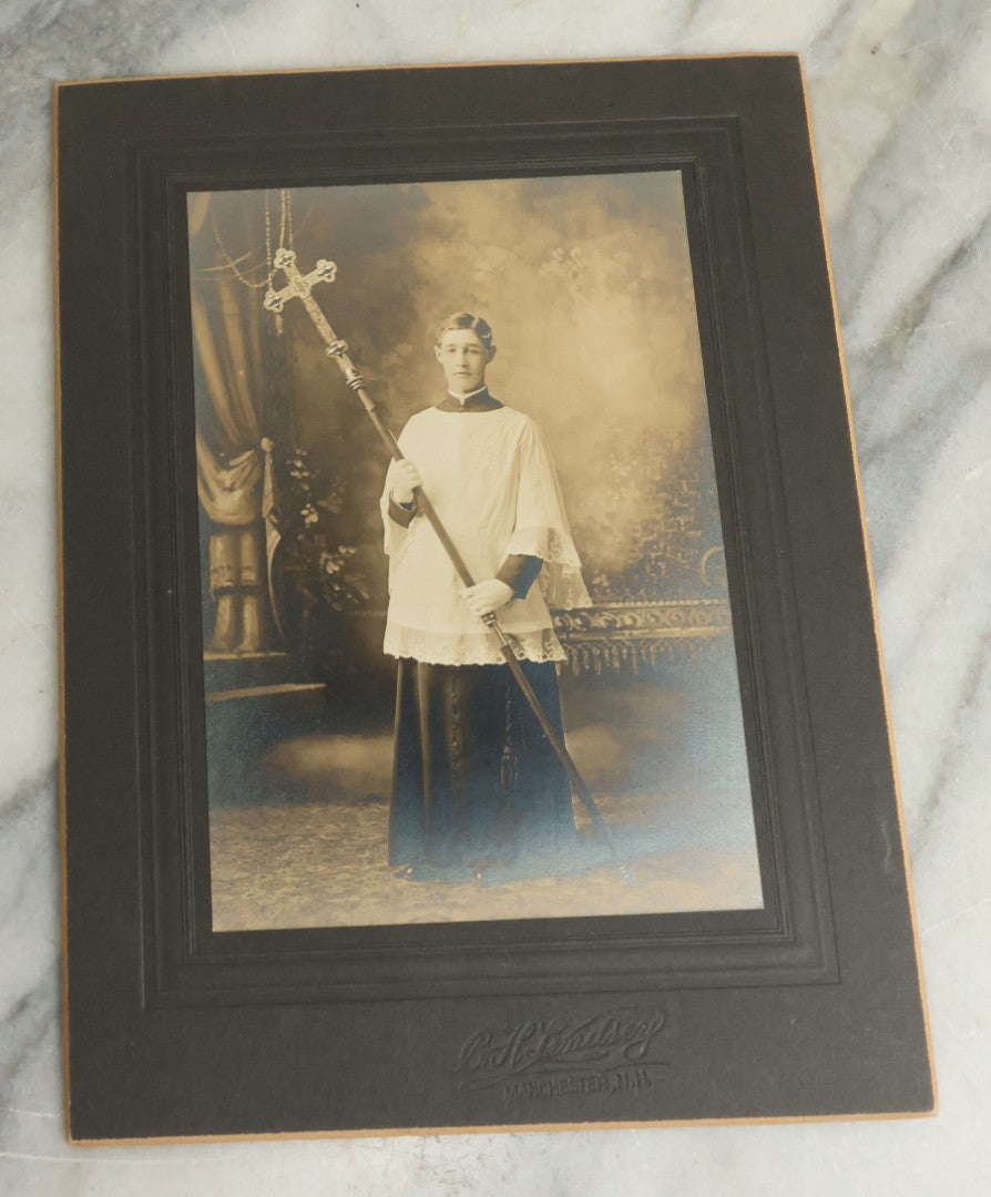 Lot 080 - Pair Of Antique Boarded Photographs Of Young Altar Boys In Their Vestments Holding The Cross On A Staff