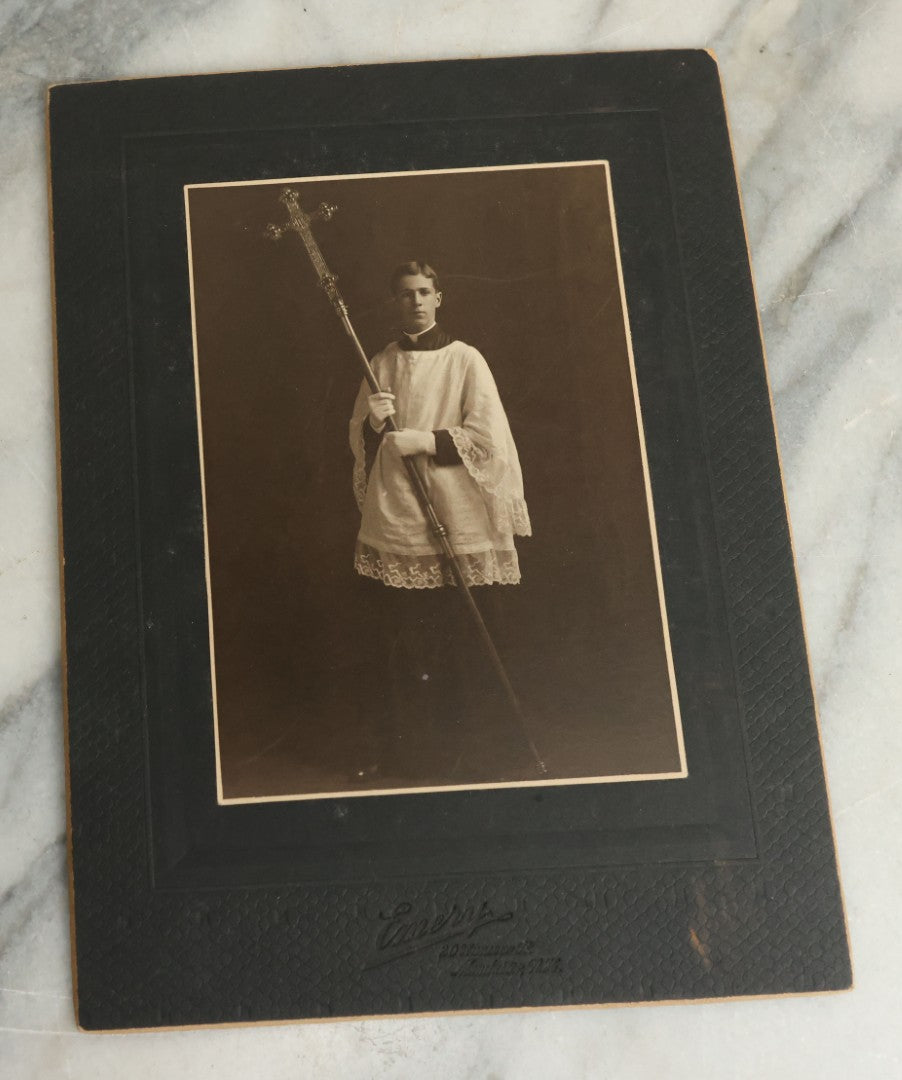 Lot 080 - Pair Of Antique Boarded Photographs Of Young Altar Boys In Their Vestments Holding The Cross On A Staff