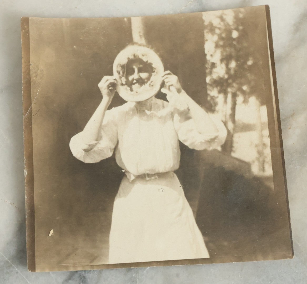 Lot 081 - Antique Snapshot Photograph Of Silly Young Woman Sticking Her Face Through Some Kind Of Cake, Photo Dated June 1908
