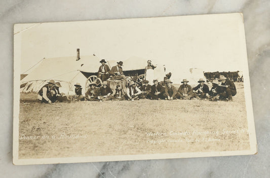 Lot 092 - Antique Real Photo Postcard R.P.P.C. Of Group Of Cowboys, Captioned "Dinner On A Roundup, Western Canada Ranching Series," Copyright 1912, By A.E. Brown
