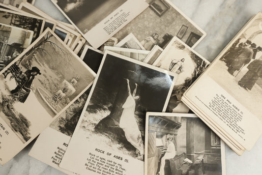 Lot 097 - Grouping Of 35 Antique Photographic Postcards From Bamforth's "Life Model Series," England And New York City, With Many Posed Studio Photographs And Series Including Rock Of Ages, The Little Hero, Excelsior, And Others