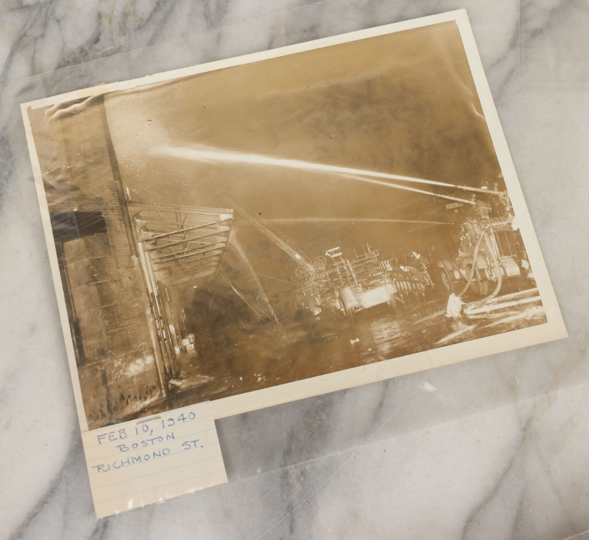 Lot 001 - Extensive Grouping Of 100+ Documentary Press Photos Of Firefighters Battling Fires, Aftermath And Destruction, And Firefighting Apperatus, In And Around The City Of Boston, Late 1930s To 1950s, With Notes Regarding Date And Location, 9" x 7"