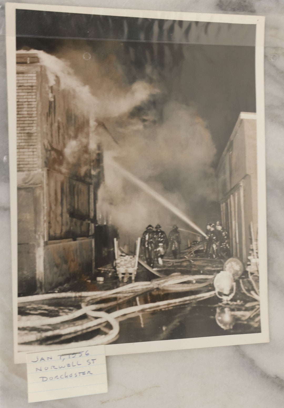 Lot 001 - Extensive Grouping Of 100+ Documentary Press Photos Of Firefighters Battling Fires, Aftermath And Destruction, And Firefighting Apperatus, In And Around The City Of Boston, Late 1930s To 1950s, With Notes Regarding Date And Location, 9" x 7"