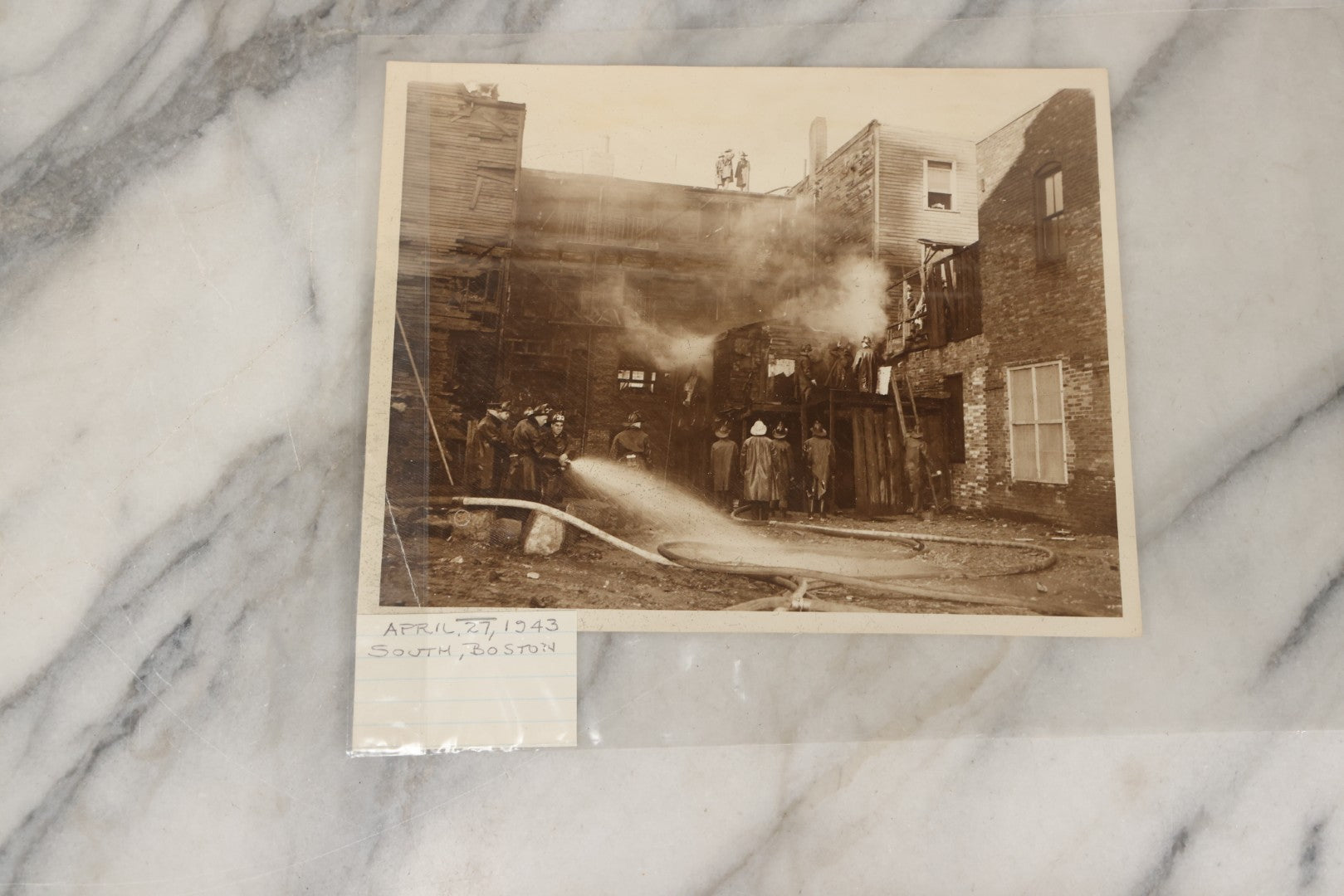 Lot 001 - Extensive Grouping Of 100+ Documentary Press Photos Of Firefighters Battling Fires, Aftermath And Destruction, And Firefighting Apperatus, In And Around The City Of Boston, Late 1930s To 1950s, With Notes Regarding Date And Location, 9" x 7"
