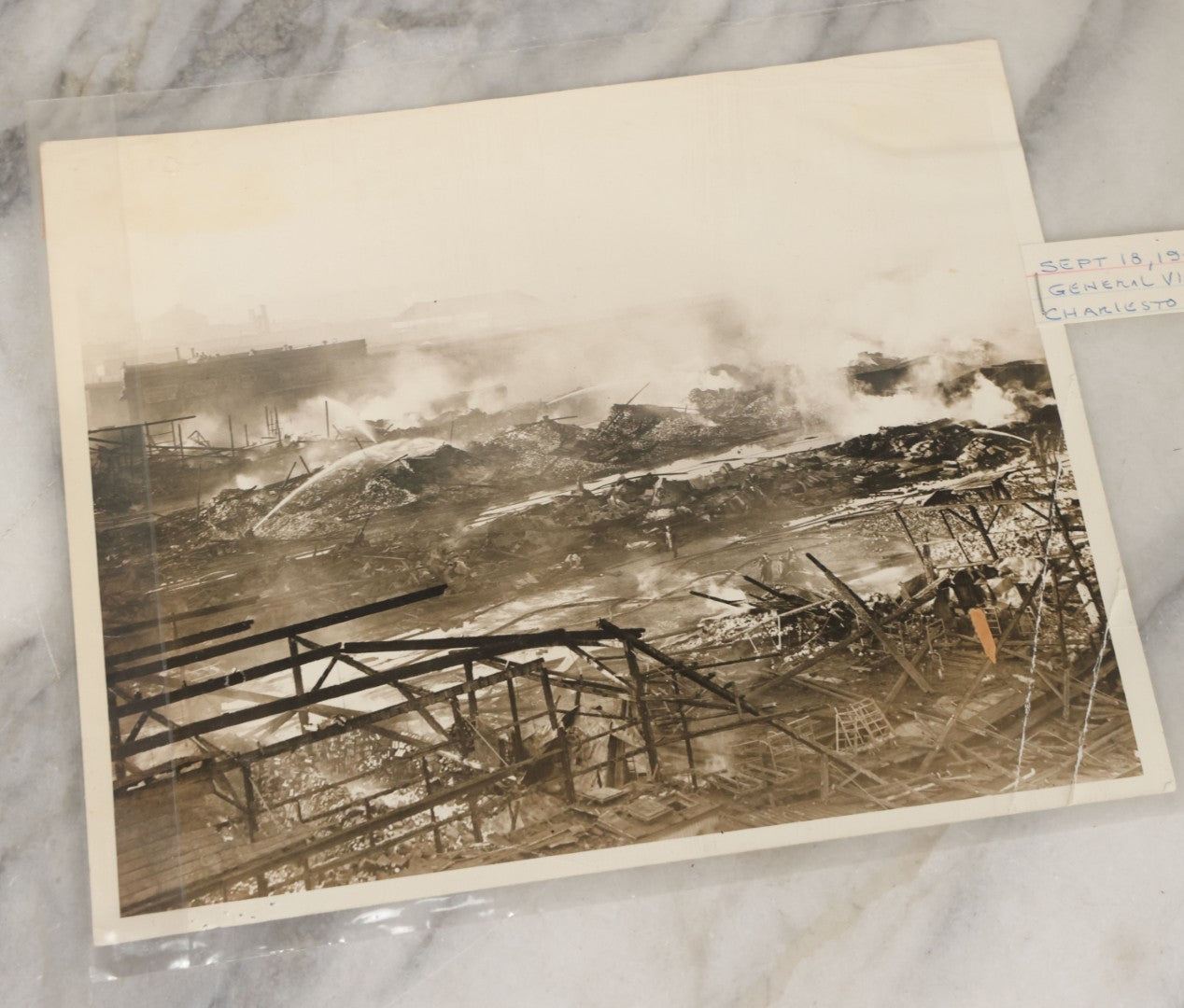Lot 001 - Extensive Grouping Of 100+ Documentary Press Photos Of Firefighters Battling Fires, Aftermath And Destruction, And Firefighting Apperatus, In And Around The City Of Boston, Late 1930s To 1950s, With Notes Regarding Date And Location, 9" x 7"