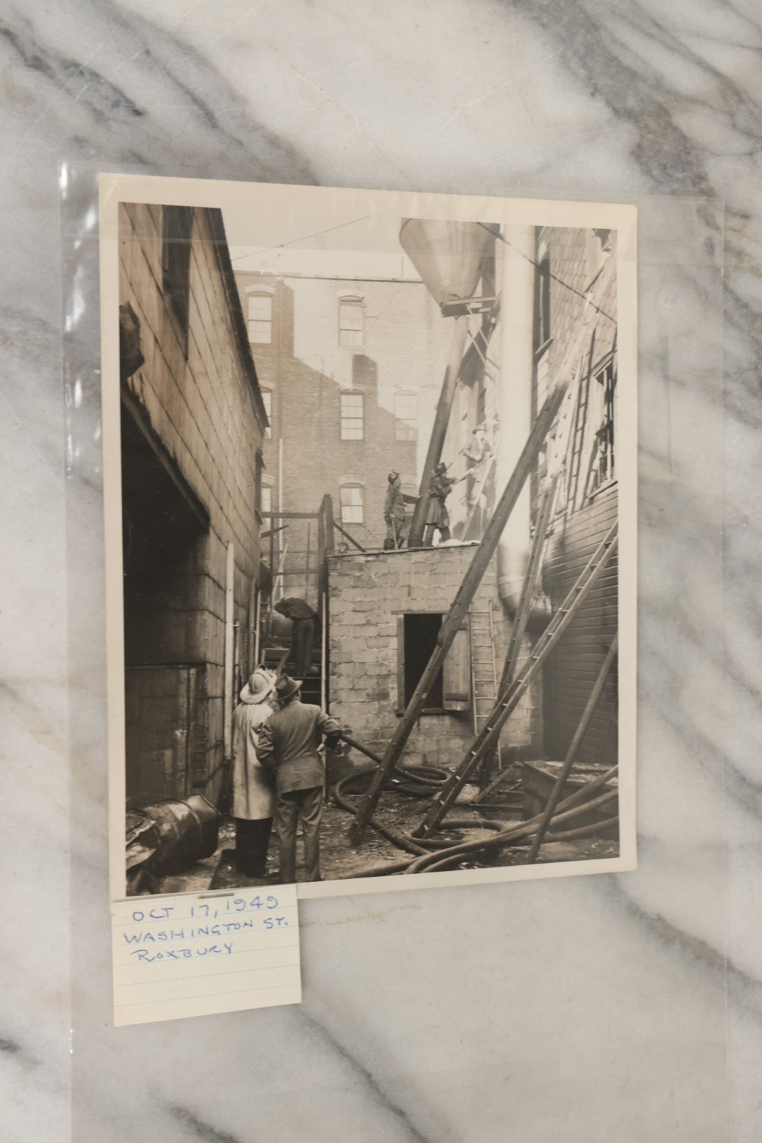 Lot 001 - Extensive Grouping Of 100+ Documentary Press Photos Of Firefighters Battling Fires, Aftermath And Destruction, And Firefighting Apperatus, In And Around The City Of Boston, Late 1930s To 1950s, With Notes Regarding Date And Location, 9" x 7"