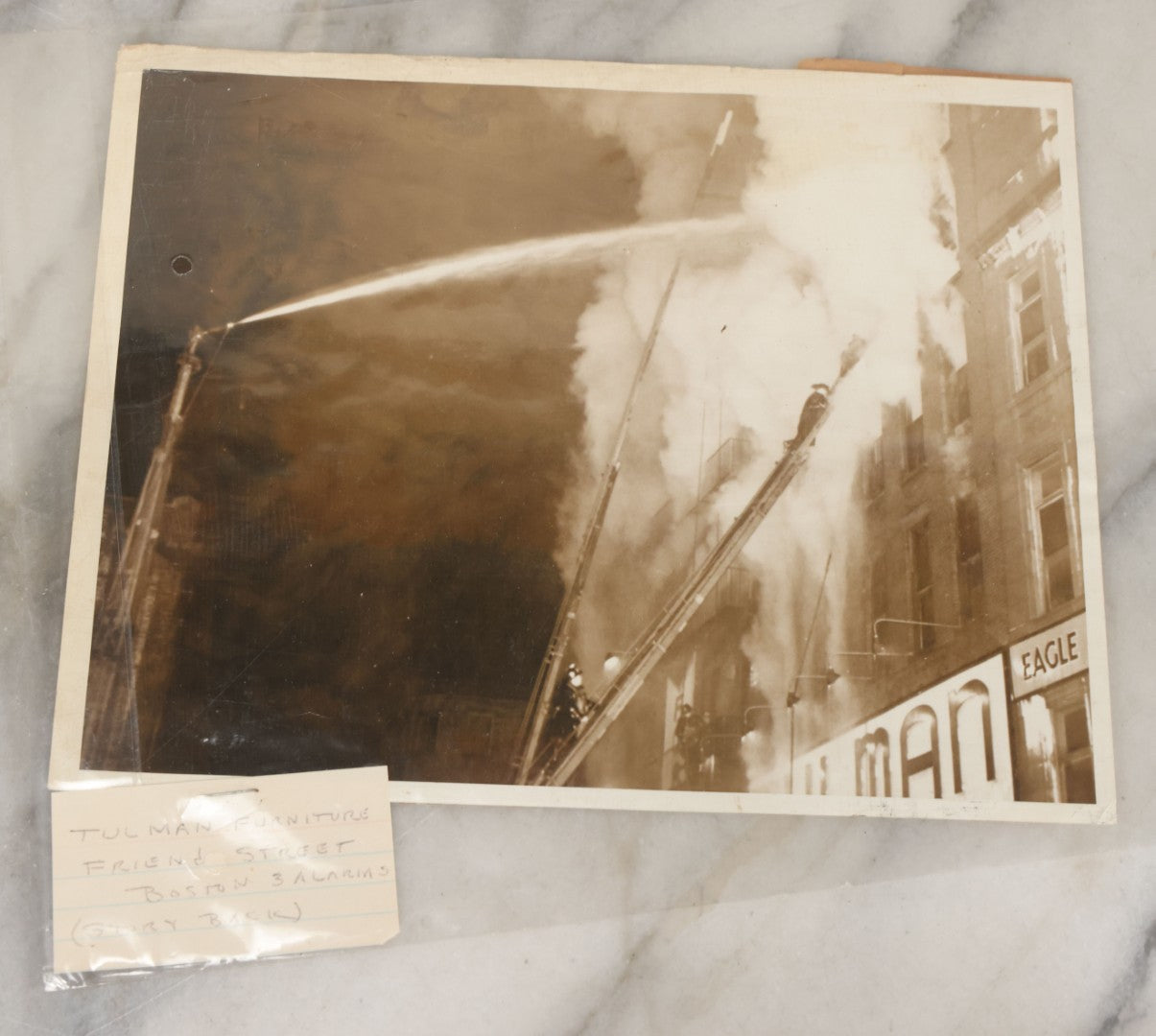 Lot 001 - Extensive Grouping Of 100+ Documentary Press Photos Of Firefighters Battling Fires, Aftermath And Destruction, And Firefighting Apperatus, In And Around The City Of Boston, Late 1930s To 1950s, With Notes Regarding Date And Location, 9" x 7"