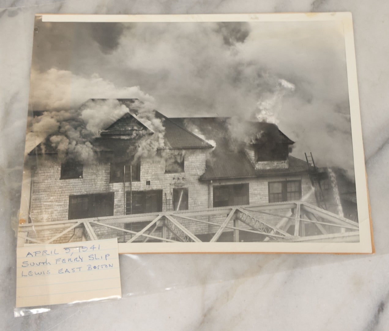 Lot 001 - Extensive Grouping Of 100+ Documentary Press Photos Of Firefighters Battling Fires, Aftermath And Destruction, And Firefighting Apperatus, In And Around The City Of Boston, Late 1930s To 1950s, With Notes Regarding Date And Location, 9" x 7"