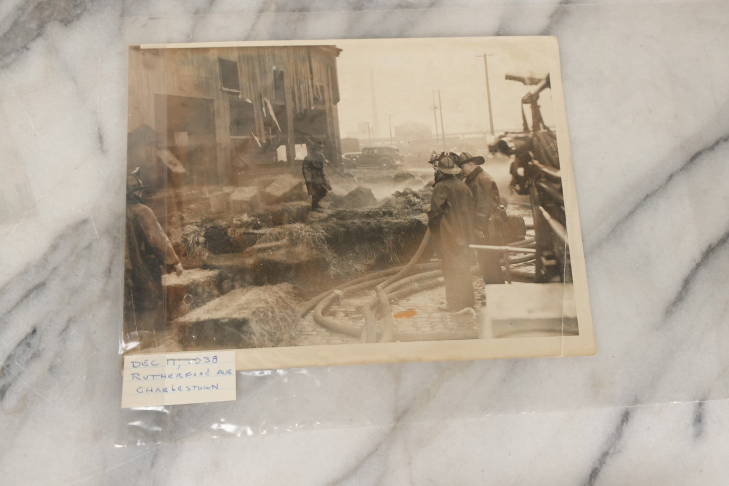 Lot 001 - Extensive Grouping Of 100+ Documentary Press Photos Of Firefighters Battling Fires, Aftermath And Destruction, And Firefighting Apperatus, In And Around The City Of Boston, Late 1930s To 1950s, With Notes Regarding Date And Location, 9" x 7"