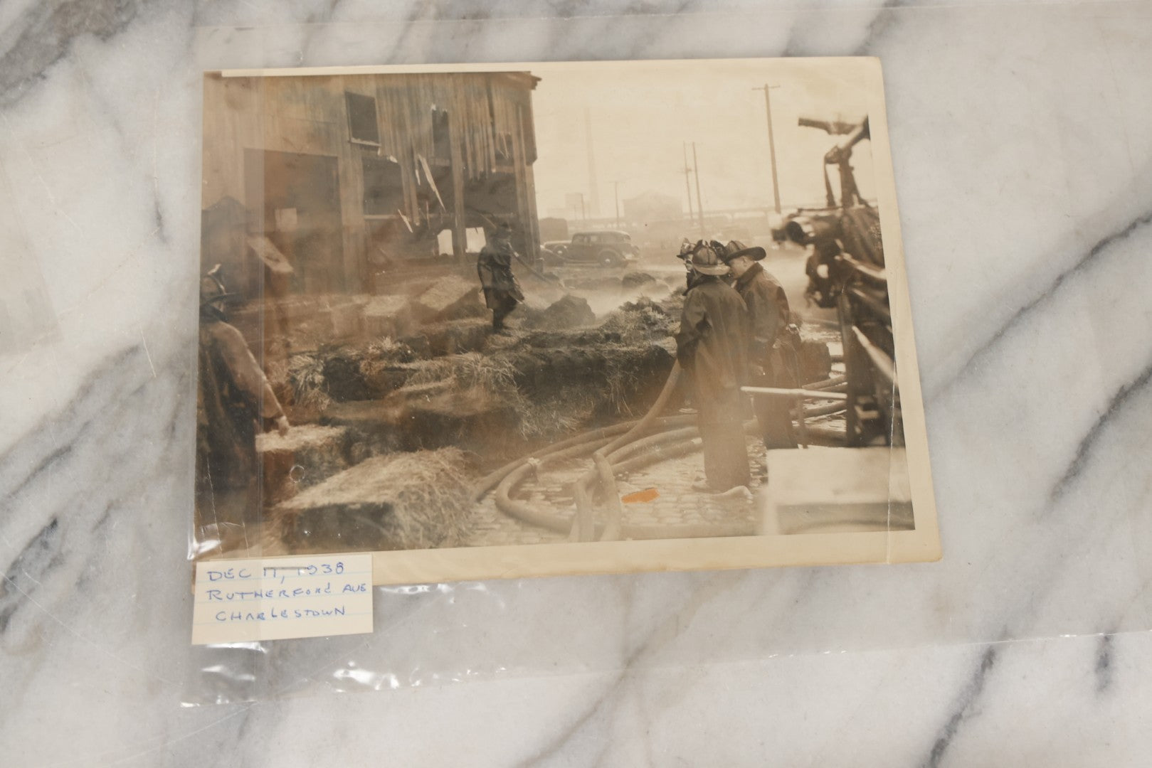 Lot 001 - Extensive Grouping Of 100+ Documentary Press Photos Of Firefighters Battling Fires, Aftermath And Destruction, And Firefighting Apperatus, In And Around The City Of Boston, Late 1930s To 1950s, With Notes Regarding Date And Location, 9" x 7"