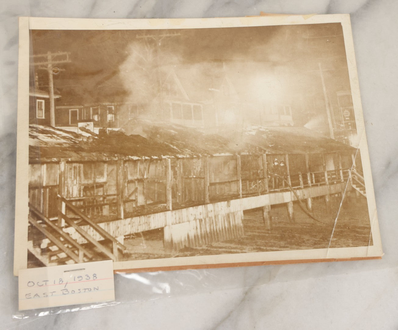 Lot 001 - Extensive Grouping Of 100+ Documentary Press Photos Of Firefighters Battling Fires, Aftermath And Destruction, And Firefighting Apperatus, In And Around The City Of Boston, Late 1930s To 1950s, With Notes Regarding Date And Location, 9" x 7"