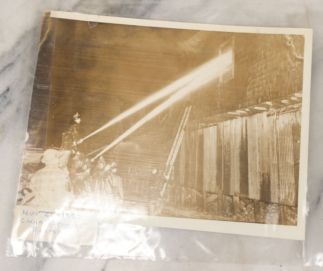 Lot 001 - Extensive Grouping Of 100+ Documentary Press Photos Of Firefighters Battling Fires, Aftermath And Destruction, And Firefighting Apperatus, In And Around The City Of Boston, Late 1930s To 1950s, With Notes Regarding Date And Location, 9" x 7"