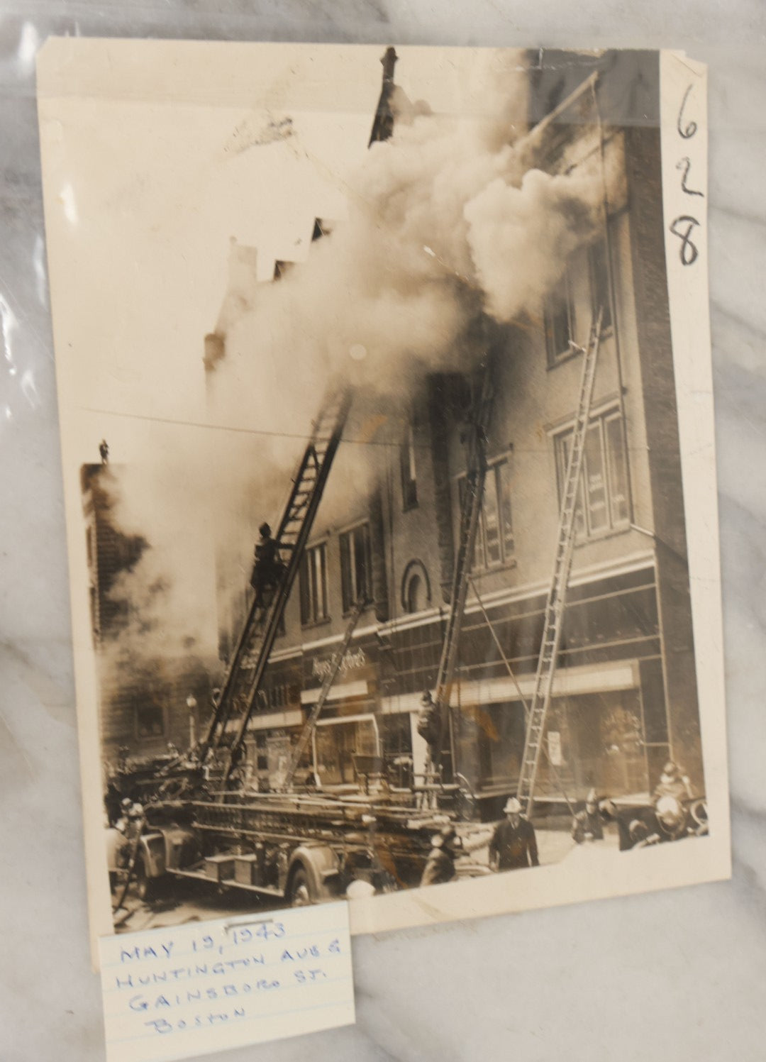 Lot 001 - Extensive Grouping Of 100+ Documentary Press Photos Of Firefighters Battling Fires, Aftermath And Destruction, And Firefighting Apperatus, In And Around The City Of Boston, Late 1930s To 1950s, With Notes Regarding Date And Location, 9" x 7"