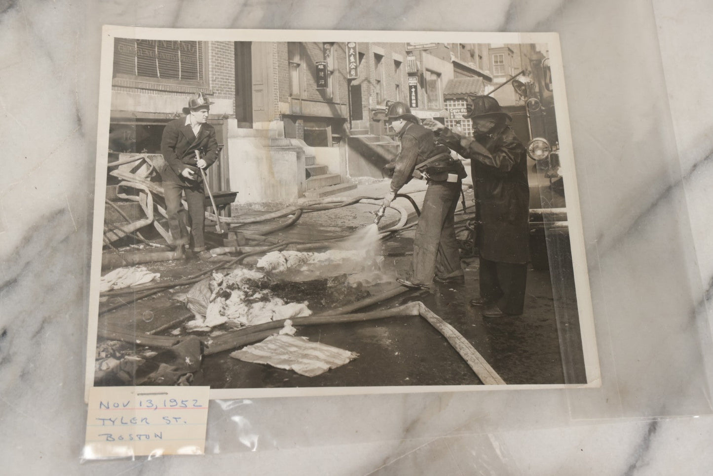 Lot 001 - Extensive Grouping Of 100+ Documentary Press Photos Of Firefighters Battling Fires, Aftermath And Destruction, And Firefighting Apperatus, In And Around The City Of Boston, Late 1930s To 1950s, With Notes Regarding Date And Location, 9" x 7"