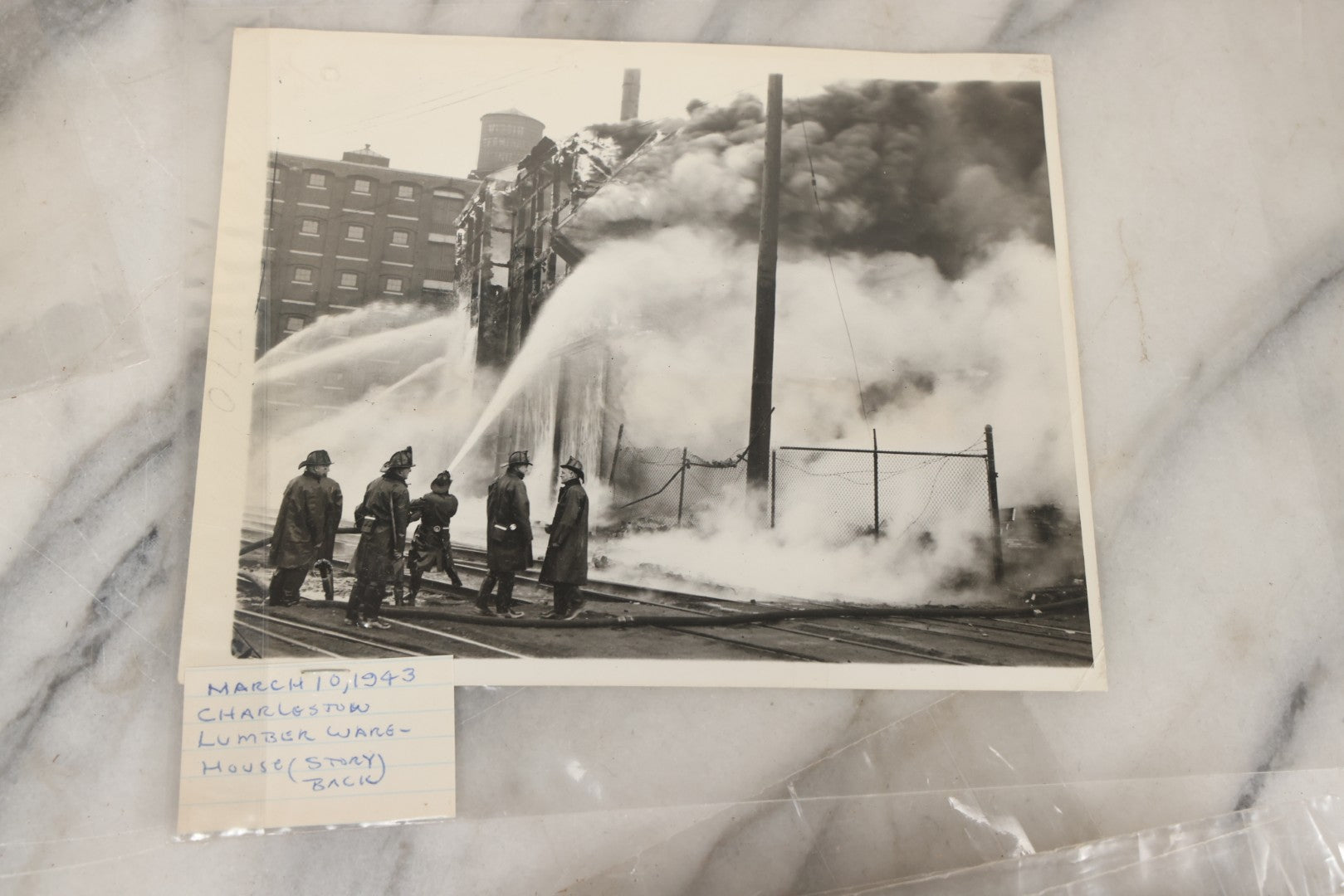 Lot 001 - Extensive Grouping Of 100+ Documentary Press Photos Of Firefighters Battling Fires, Aftermath And Destruction, And Firefighting Apperatus, In And Around The City Of Boston, Late 1930s To 1950s, With Notes Regarding Date And Location, 9" x 7"