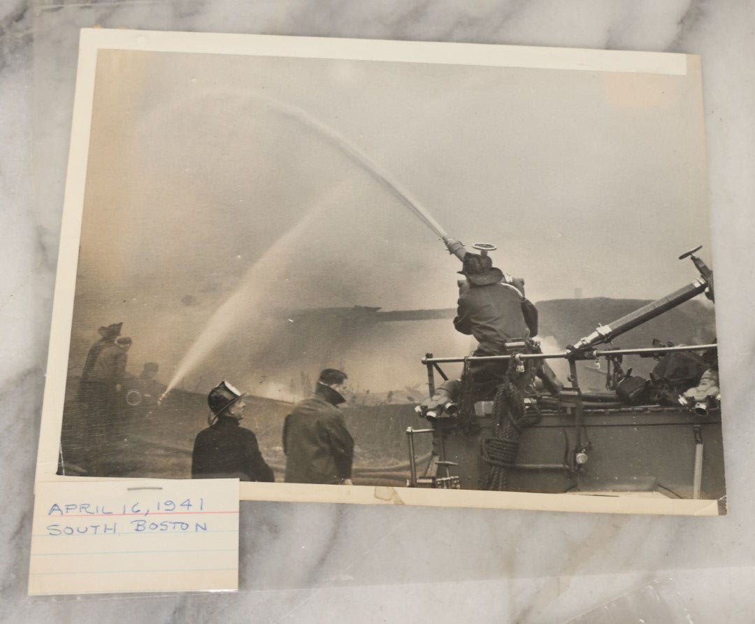 Lot 001 - Extensive Grouping Of 100+ Documentary Press Photos Of Firefighters Battling Fires, Aftermath And Destruction, And Firefighting Apperatus, In And Around The City Of Boston, Late 1930s To 1950s, With Notes Regarding Date And Location, 9" x 7"
