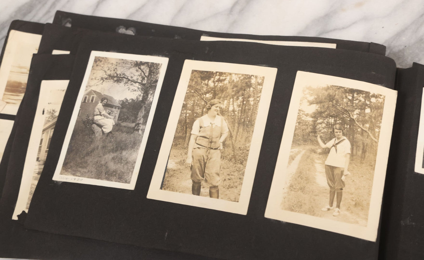 Lot 065 - Vintage Snapshot Photo Album With 95+ Photographs Of The Men And Women Of The 1920s Including Many Photos Of Lakeside Gatherings, Flappers, Swimsuits, And WWI Era Soldiers