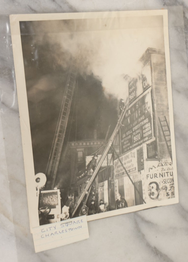 Lot 001 - Extensive Grouping Of 100+ Documentary Press Photos Of Firefighters Battling Fires, Aftermath And Destruction, And Firefighting Apperatus, In And Around The City Of Boston, Late 1930s To 1950s, With Notes Regarding Date And Location, 9" x 7"