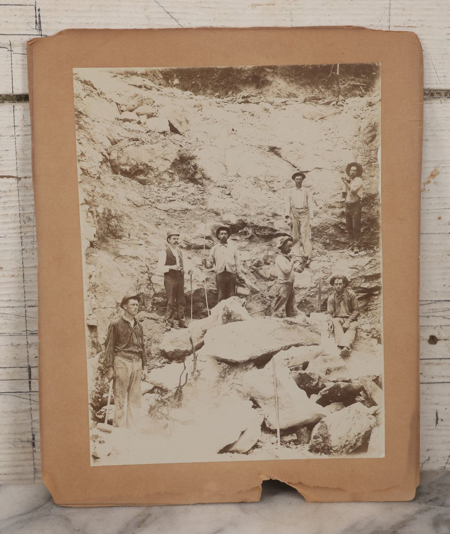 Lot 067 - Antique Boarded Occupational Photograph Of Group Of Seven Miners Posing In Quarry, Holding Sledgehammers And Other Tools