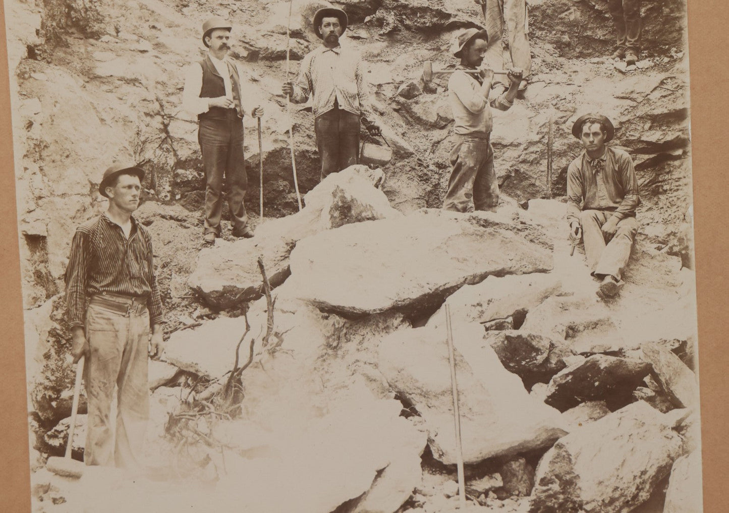 Lot 067 - Antique Boarded Occupational Photograph Of Group Of Seven Miners Posing In Quarry, Holding Sledgehammers And Other Tools