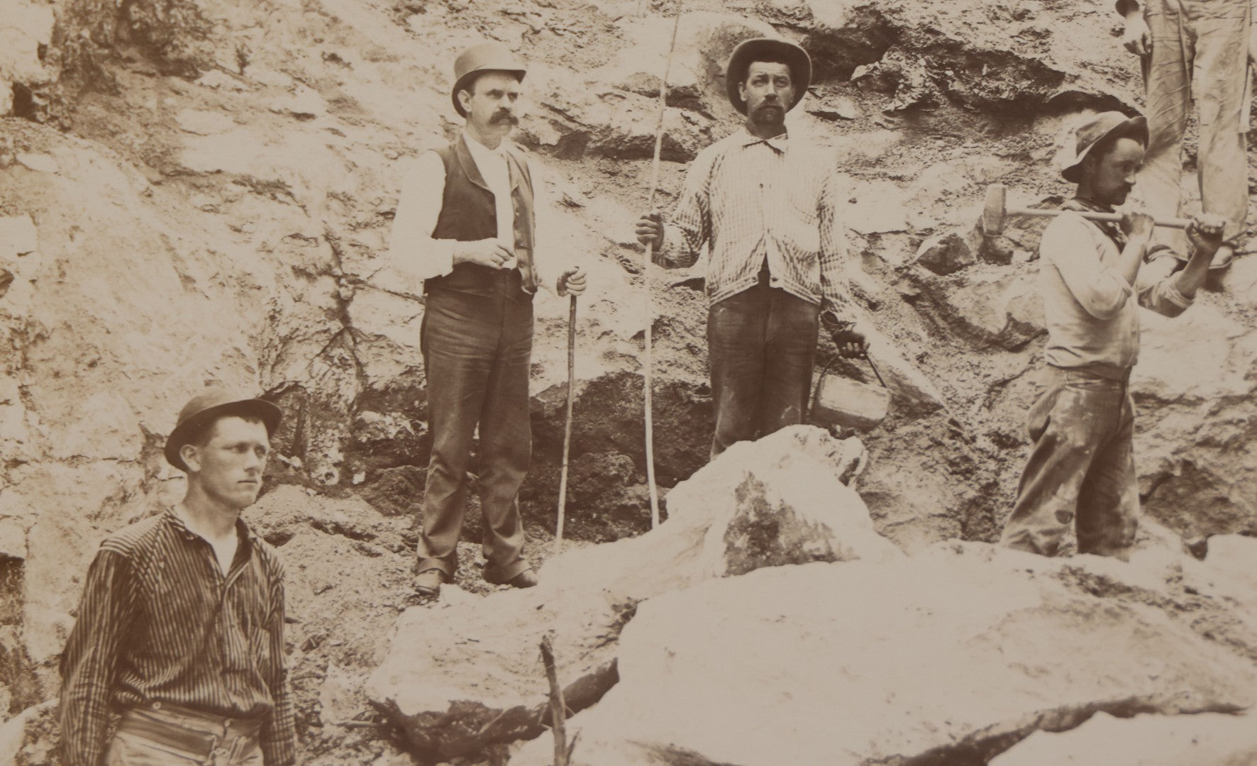 Lot 067 - Antique Boarded Occupational Photograph Of Group Of Seven Miners Posing In Quarry, Holding Sledgehammers And Other Tools