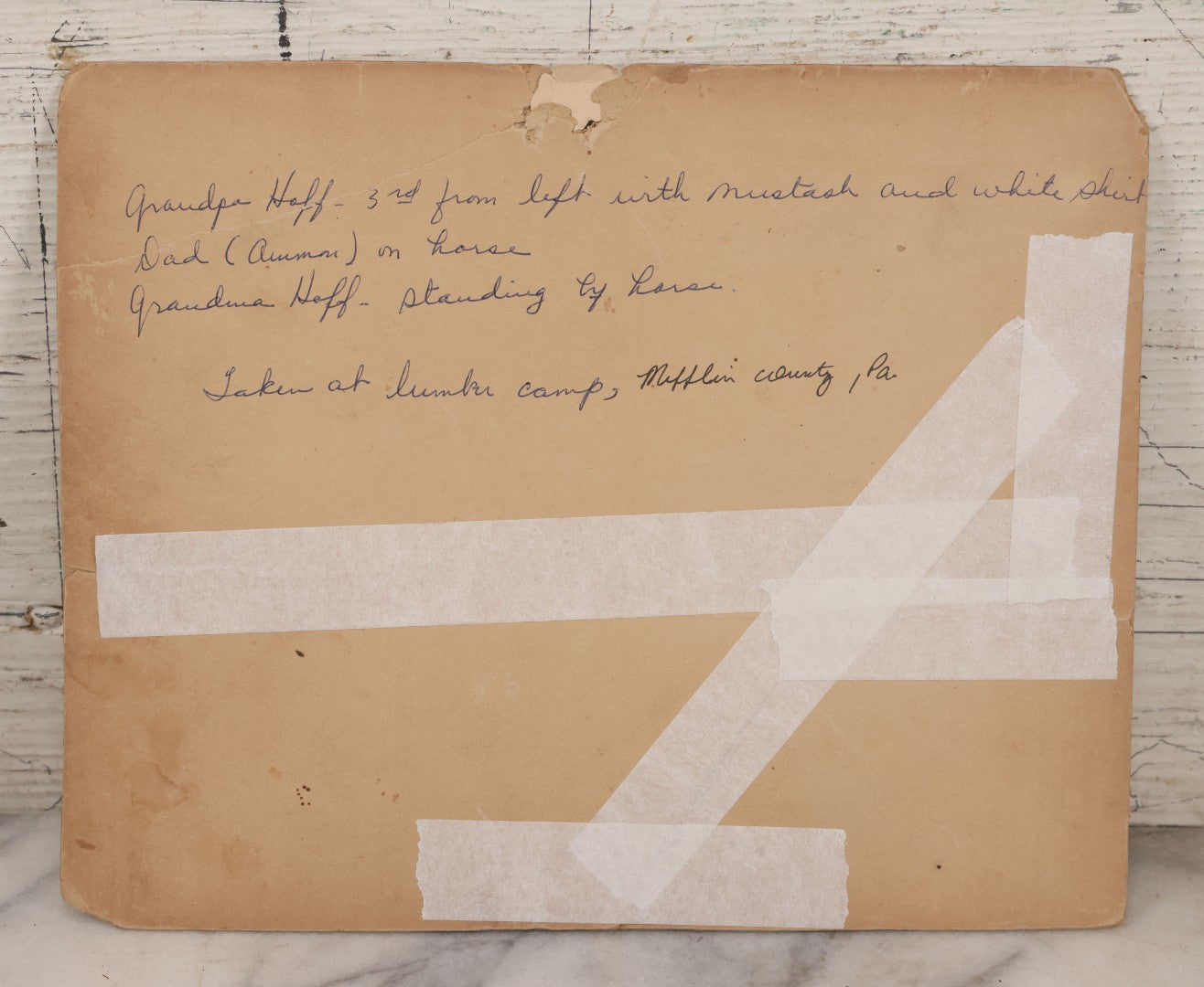 Lot 068 - Antique Boarded Occupational Photograph Of Group Of Lumber Workers Posing At A Lumber Camp In Mifflin County, Pennsylvania, Partial Identification On Verso Of "Grandpa Hoff", Bicycle And Horse In Photo, Note Cracking And Wear