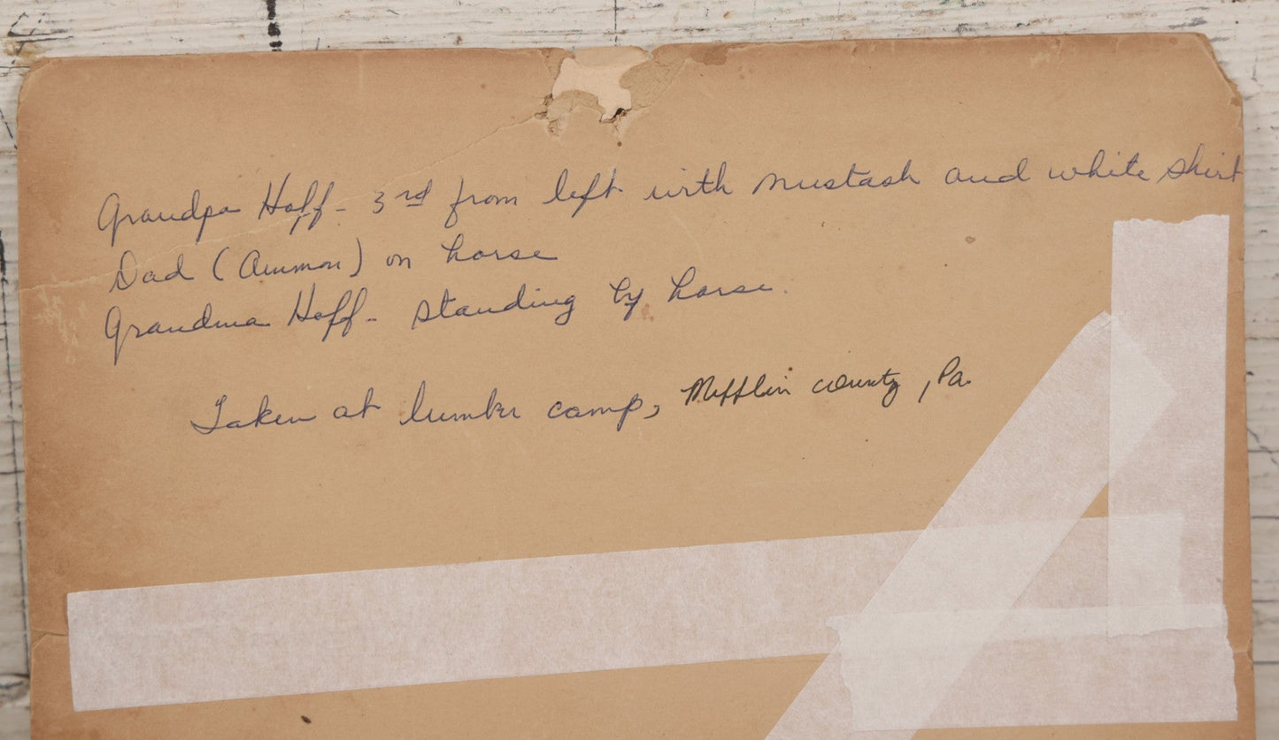 Lot 068 - Antique Boarded Occupational Photograph Of Group Of Lumber Workers Posing At A Lumber Camp In Mifflin County, Pennsylvania, Partial Identification On Verso Of "Grandpa Hoff", Bicycle And Horse In Photo, Note Cracking And Wear