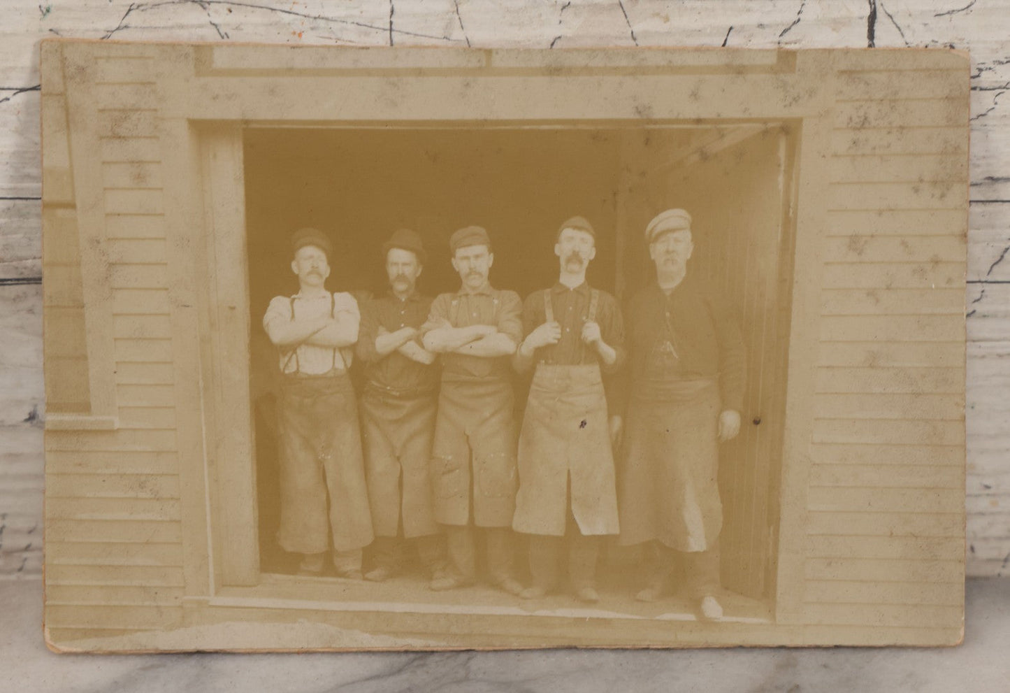Lot 070 - Antique Flush Mount Boarded Occupational Photograph Of Group Of Five Burly Workers Posing In A Doorway, James A. Phinney Identified, Boston Photographer Mark On Verso
