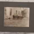 Lot 071 - Antique Boarded Occupational Photograph Of Group Of Seven Dirty Workers Posing In Work Clothes Outside Brick Workplace