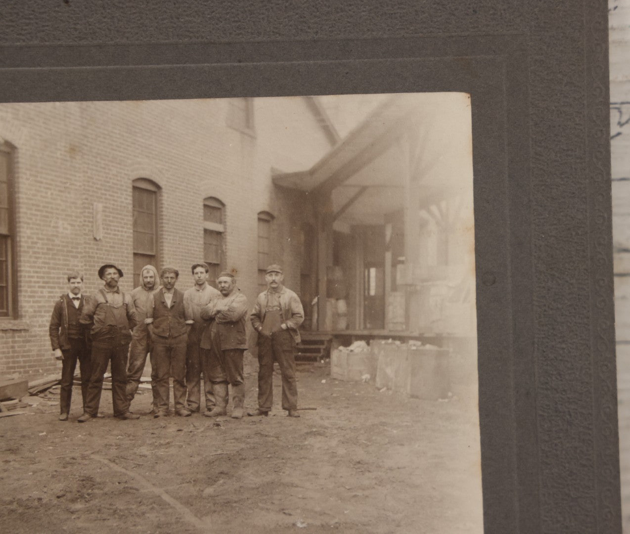 Lot 071 - Antique Boarded Occupational Photograph Of Group Of Seven Dirty Workers Posing In Work Clothes Outside Brick Workplace