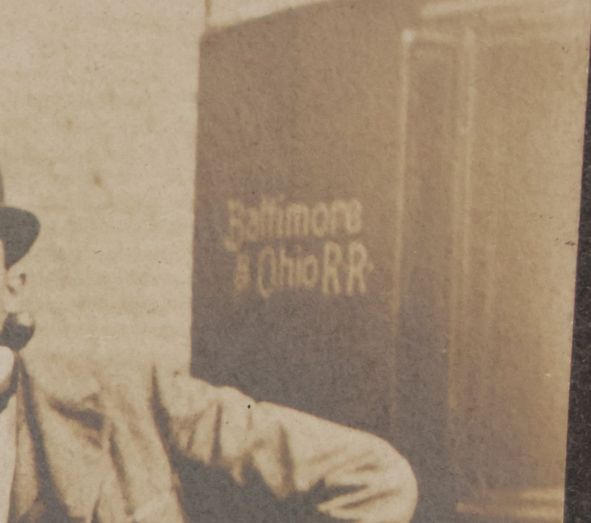 Lot 072 - Antique Boarded Occupational Photograph Of Three Men Smoking Pipes And Posing With Turn Of The Century Automobile, With Baltimore & Ohio Railroad Carriage Visible In Background, Handwritten Note On Verso, Dated October 9, 1901