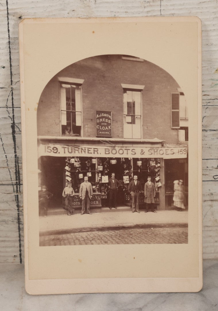 Lot 073 - Antique Cabinet Card Photograph Of The Workers And Proprietors Posing Outside Of The Storefront Of Turner Boots & Shoes And A.J. Smith Dress And Cloakmaking, New York