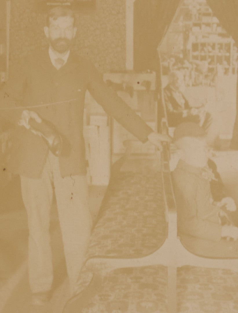 Lot 076 - Antique Boarded Photograph Of Three Men And Young Boy In Boot And Shoe Store, With Products And Advertising Visible In Photo