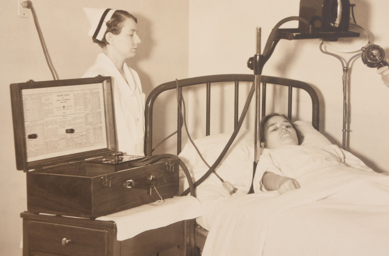 Lot 080 - Vintage Photograph In Paper Frame Of Woman In Hospital Bed With Her Nurse And Doctor About To Utilize An Unknown Medical Apperatus, C.L. Smith & Co., Photographers, Norwood, Massachusetts